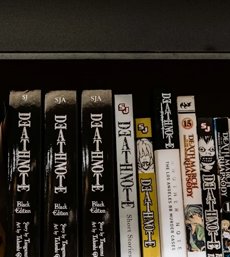 shelf of manga featuring death note